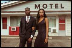 Chelsea, wearing 90's black beaded maxi dress. Franklin, wearing a pin stripe, three-piece suit with a basic white button up shirt and tie.