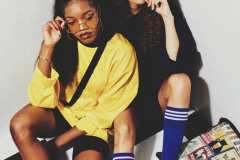 Diane, wearing 90's yellow Nike jersey, Esprit shoulder bag. Andrea, wearing navy sport jersey, blue knee-high socks.