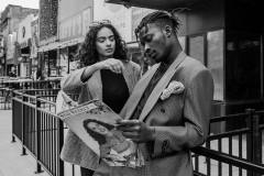 Yumna, wearing 80's pleated, grey wool pants, plaid 80's blazer. Franklin, wearing brown 70's two-piece suit, suspenders, gingham pocket square.