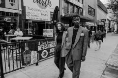 Yumna, wearing 80's pleated, grey wool pants, plaid 80's blazer. Franklin, wearing brown 70's two-piece suit, suspenders, gingham pocket square.