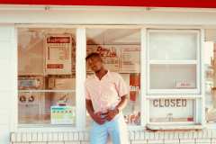 Franklin, wearing powder blue dress pants,50's red and white stripe button up shirt, paired with matching brown leather, blue and white stripe belt.