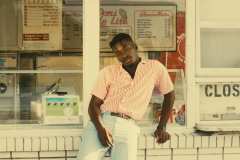 Franklin, wearing powder blue dress pants,50's red and white stripe button up shirt, paired with matching brown leather, blue and white stripe belt.